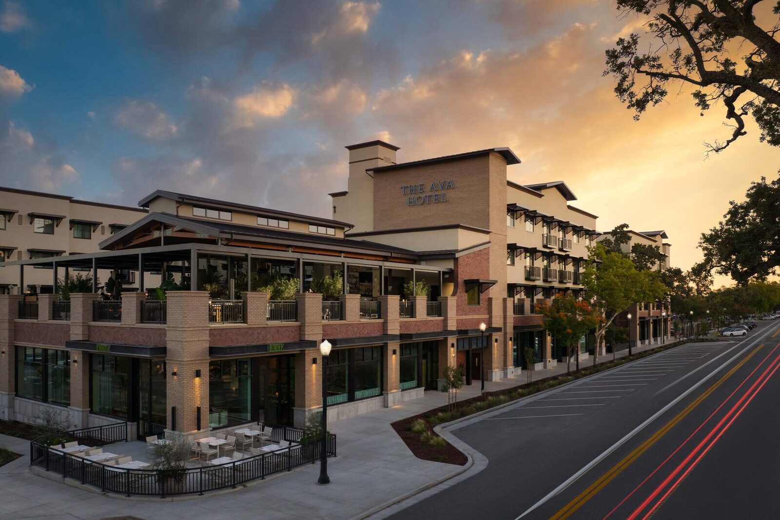 The Ava Hotel's brick facade and rooftop terrace at sunset in downtown Paso Robles