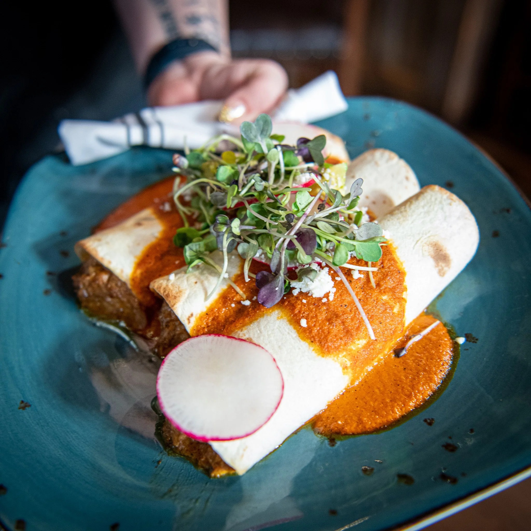 Plated dish with red sauce, microgreens, and radish at a Paso Robles restaurant